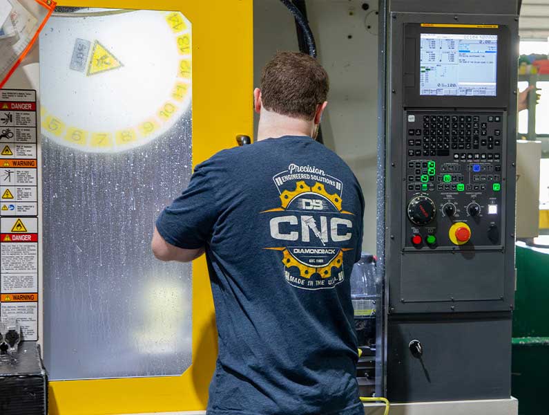 Technician operating CNC machine